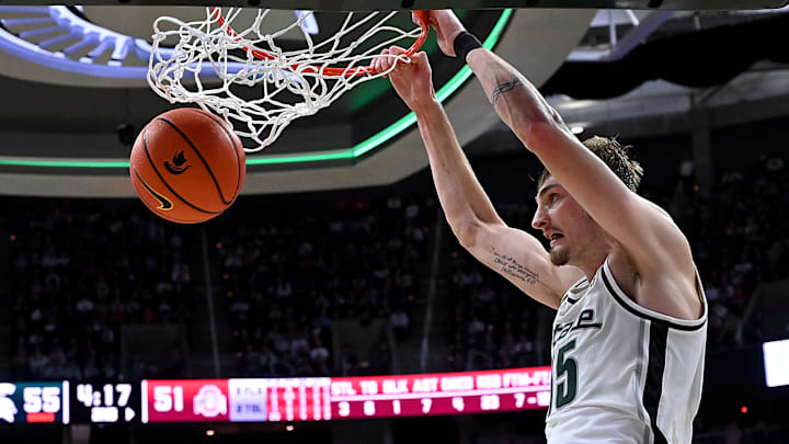 Feb 22, 2026; East Lansing, Michigan, USA; Michigan State Spartans center Carson Cooper (15) dunks the ball against the Ohio State Buckeyes during the second half at Jack Breslin Student Events Center. Mandatory Credit: Dale Young-Imagn Images Feb 22, 2026; East Lansing, Michigan, USA; Michigan State Spartans center Carson Cooper (15) dunks the ball against the Ohio State Buckeyes during the second half at Jack Breslin Student Events Center. Mandatory Credit: Dale Young-Imagn Images