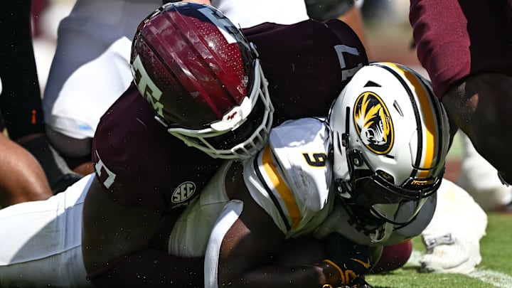 Texas A&M Aggies defensive lineman Albert Regis stops Missouri Tigers running back Marcus Carroll in the fourth quarter at Kyle Field.