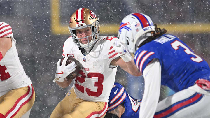 Dec 1, 2024; Orchard Park, New York, USA; San Francisco 49ers running back Christian McCaffrey (23) tries to avoid Buffalo Bills safety Damar Hamlin (3) on a run in the first quarter at Highmark Stadium. Mandatory Credit: Mark Konezny-Imagn Images