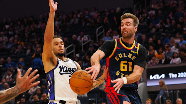 Jan 5, 2025; San Francisco, California, USA; Golden State Warriors guard Pat Spencer (61) passes the ball against Sacramento Kings guard Devin Carter (22) during the fourth quarter at Chase Center. Mandatory Credit: Kelley L Cox-Imagn Images