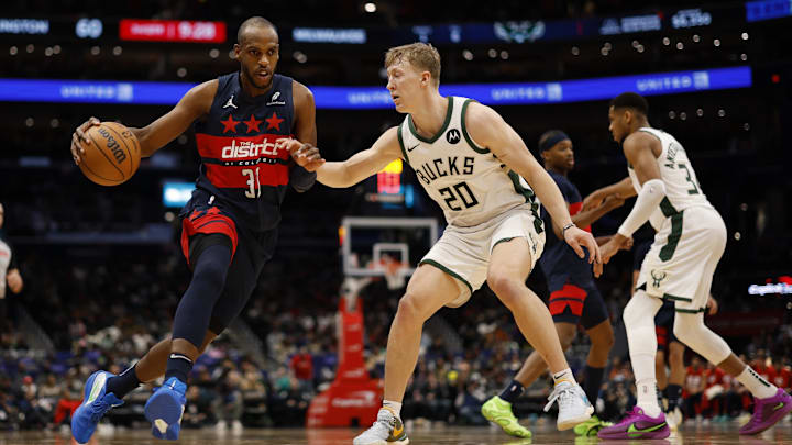 Feb 21, 2025; Washington, District of Columbia, USA: Washington Wizards forward Khris Middleton (32) drives to the basket as Milwaukee Bucks guard AJ Green (20) defends in the second half at Capital One Arena. Mandatory Credit: Geoff Burke-Imagn Images