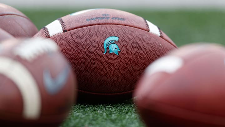 Oct 12, 2019; Madison, WI, USA; Michigan State Spartans logo on footballs during warmups prior to the game against the Wisconsin Badgers at Camp Randall Stadium. Mandatory Credit: Jeff Hanisch-Imagn Images