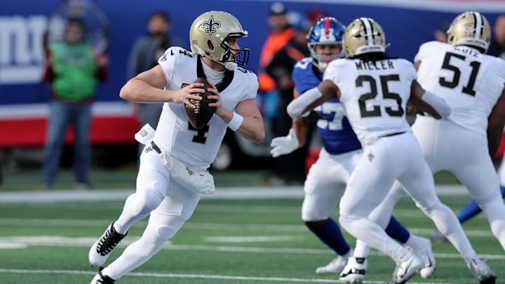 Dec 8, 2024; East Rutherford, New Jersey, USA; New Orleans Saints quarterback Derek Carr (4) looks to pass against the New York Giants during the first quarter at MetLife Stadium. Mandatory Credit: Brad Penner-Imagn Images