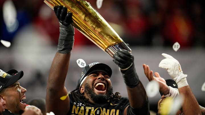 Ohio State wide receiver Jeremiah Smith holds the College Football Playoff championship trophy after the Buckeyes' 34-23 win over Notre Dame on Jan. 21, 2025.