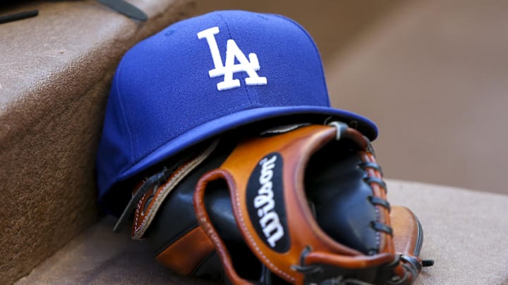 Aug 16, 2019; Atlanta, GA, USA; Detailed view of Los Angeles Dodgers hat and glove in the dugout against the Atlanta Braves in the first inning at SunTrust Park. Mandatory Credit: Brett Davis-Imagn Images Aug 16, 2019; Atlanta, GA, USA; Detailed view of Los Angeles Dodgers hat and glove in the dugout against the Atlanta Braves in the first inning at SunTrust Park. Mandatory Credit: Brett Davis-Imagn Images