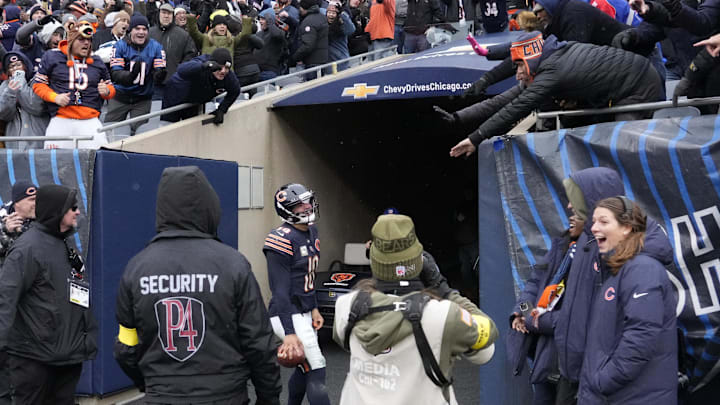 Caleb Williams celebrates with fans after scoring on a 17-yard run for the 24-20 win at Soldier Field.