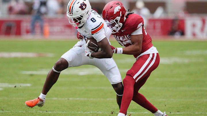 Auburn Tigers wide receiver Cam Coleman (8) is tackled after a catch by Arkansas Razorbacks defensive back Julian Neal (23).