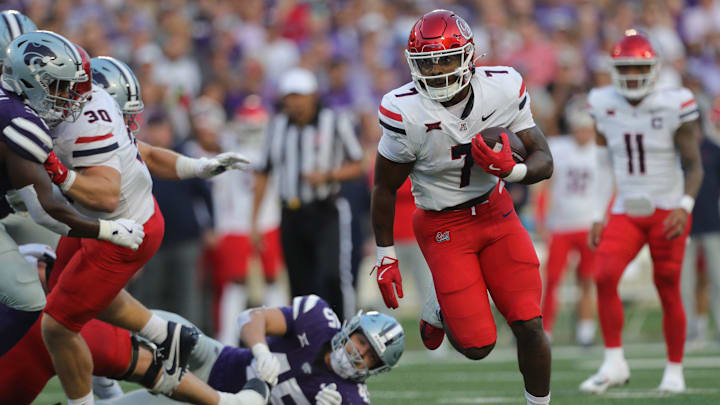 Arizona Wildcats running back Quali Conley (7) runs the ball during the first quarter of the game against Kansas State at Bill Snyder Family Stadium Friday, September 13, 2024. Arizona Wildcats running back Quali Conley (7) runs the ball during the first quarter of the game against Kansas State at Bill Snyder Family Stadium Friday, September 13, 2024.