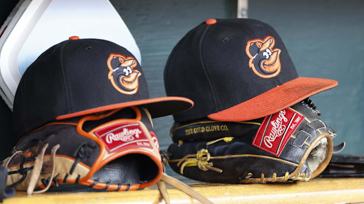 Apr 27, 2023; Detroit, Michigan, USA;  Baltimore Orioles hats and glove sits in dugout in the second inning against the Detroit Tigers at Comerica Park. Mandatory Credit: Rick Osentoski-Imagn Images