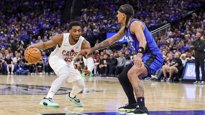 Cleveland Cavaliers guard Donovan Mitchell (45) handles the ball against Orlando Magic forward Paolo Banchero (5) during the second half of game six of the first round for the 2024 NBA playoffs at Kia Center. Cleveland Cavaliers guard Donovan Mitchell (45) handles the ball against Orlando Magic forward Paolo Banchero (5) during the second half of game six of the first round for the 2024 NBA playoffs at Kia Center.