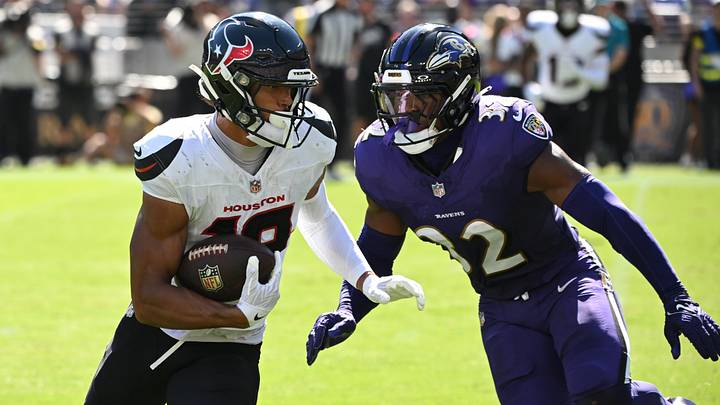 Oct 5, 2025; Baltimore, Maryland, USA; Houston Texans wide receiver Xavier Hutchinson (19) runs for a gain past Baltimore Ravens linebacker Trenton Simpson (32) during the second quarter at M&T Bank Stadium. Mandatory Credit: Rafael Suanes-Imagn Images