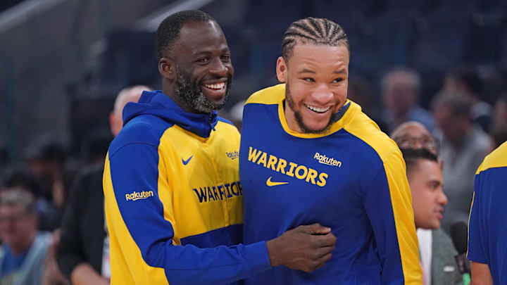 Apr 9, 2025; San Francisco, California, USA; Golden State Warriors forward Draymond Green (23) is congratulated by forward Kevin Knox II (31) after receiving the Defensive Player of the Month award before the game against the San Antonio Spurs at Chase Center. Mandatory Credit: David Gonzales-Imagn Images