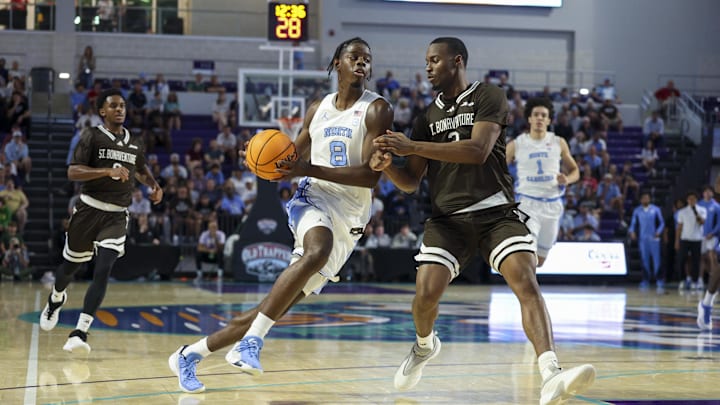 Nov 25, 2025; Fort Myers, Florida, USA; North Carolina Tar Heels forward Caleb Wilson (8) drives to the basket past St. Bonaventure Bonnies forward Daniel Egbuniwe (3) in the first half  at Suncoast Credit Union Arena. Mandatory Credit: Nathan Ray Seebeck-Imagn Images