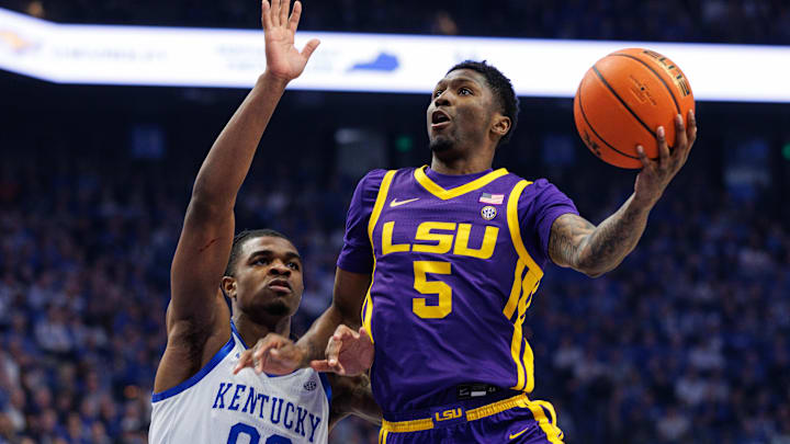 Mar 4, 2025; Lexington, Kentucky, USA; LSU Tigers guard Cam Carter (5) goes to the basket against Kentucky Wildcats guard Otega Oweh (00) during the first half at Rupp Arena at Central Bank Center. Mandatory Credit: Jordan Prather-Imagn Images Mar 4, 2025; Lexington, Kentucky, USA; LSU Tigers guard Cam Carter (5) goes to the basket against Kentucky Wildcats guard Otega Oweh (00) during the first half at Rupp Arena at Central Bank Center. Mandatory Credit: Jordan Prather-Imagn Images
