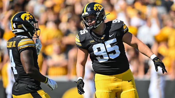 Sep 2, 2023; Iowa City, Iowa, USA; Iowa Hawkeyes defensive lineman Aaron Graves (95) and running back Leshon Williams (4) in action during the game against the Utah State Aggies at Kinnick Stadium. Mandatory Credit: Jeffrey Becker-Imagn Images