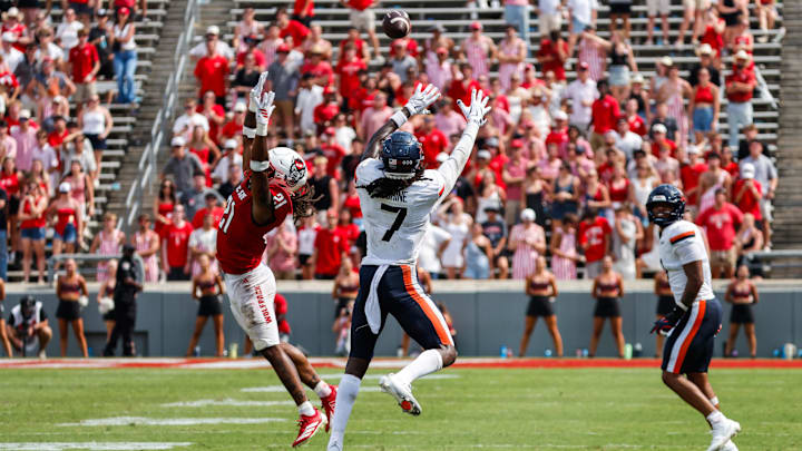 Sep 6, 2025; Raleigh, North Carolina, USA; Virginia Cavaliers wide receiver Jahmal Edrine (7) catches the pass, past North Carolina State Wolfpack cornerback Jamel Johnson (21) during the second half of the game at Carter-Finley Stadium. Mandatory Credit: Jaylynn Nash-Imagn Images Sep 6, 2025; Raleigh, North Carolina, USA; Virginia Cavaliers wide receiver Jahmal Edrine (7) catches the pass, past North Carolina State Wolfpack cornerback Jamel Johnson (21) during the second half of the game at Carter-Finley Stadium. Mandatory Credit: Jaylynn Nash-Imagn Images
