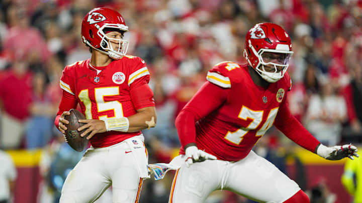 Oct 7, 2024; Kansas City, Missouri, USA; Kansas City Chiefs quarterback Patrick Mahomes (15) drops back to pass as offensive tackle Jawaan Taylor (74) gets ready to block during the first half against the New Orleans Saints at GEHA Field at Arrowhead Stadium. Mandatory Credit: Jay Biggerstaff-Imagn Images