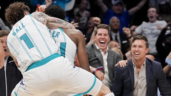 Nov 6, 2024; Charlotte, North Carolina, USA;  Fans react as Charlotte Hornets guard LaMelo Ball (1) jumps on the back of forward Brandon Miller (24) after his final second put back wins the game against the Detroit Pistons during the second half at Spectrum Center. Mandatory Credit: Jim Dedmon-Imagn Images