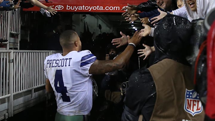 Dallas Cowboys quarterback Dak Prescott shakes hands with fans after the Cowboys' game against the Washington Commanders. 