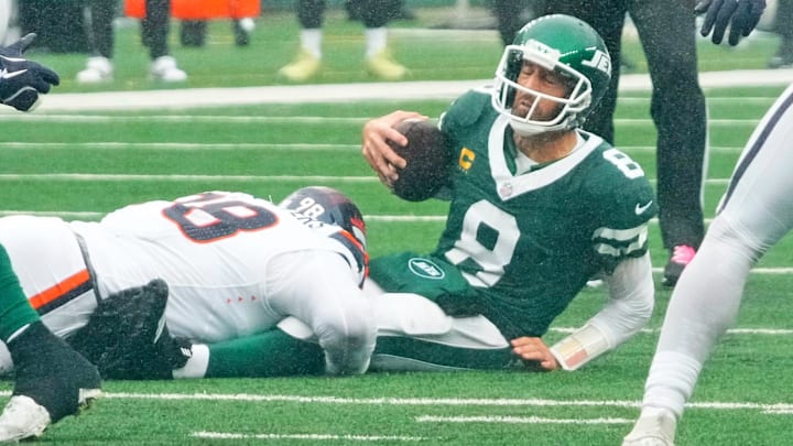 New York Jets quarterback Aaron Rodgers (8) is sacked by Denver Broncos defensive end John Franklin-Myers (98) during the second quarter at MetLife Stadium.