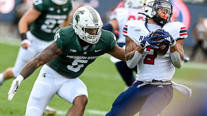 Michigan State's Jordan Hall, left, tackles Richmond's Savon Smith during the second quarter on