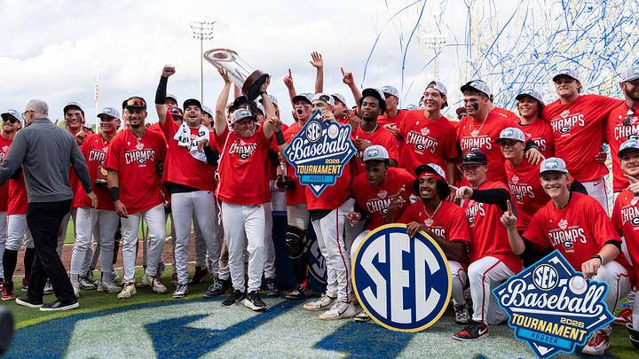 Georgia Bulldogs head coach Wes Johnson hoists the championship trophy as Georgia Bulldogs take on Arkansas Razorbacks during the SEC baseball tournament championship game at Hoover Metropolitan Stadium in Hoover, Ala. on Sunday, May 24, 2026. Georgia Bulldogs defeated Arkansas Razorbacks 11-1