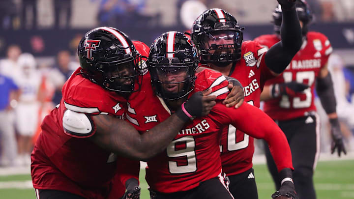 Texas Tech players Lee Hunter (left) and Jacob Rodriguez (back) celebrate Romello Height's fumble recover against BYU during the Big 12 Conference championship football game, Saturday, Nov. 6, 2025, at AT&T Stadium in Arlington.
