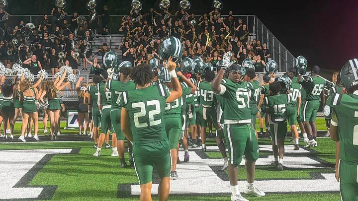 Muskogee players celebrate with their band after a recent victory. Muskogee players celebrate with their band after a recent victory.