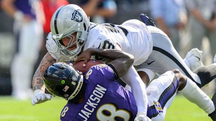 Sep 15, 2024; Baltimore, Maryland, USA; Las Vegas Raiders defensive end Maxx Crosby (98) sacks Baltimore Ravens quarterback Lamar Jackson (8) during the second half at M&T Bank Stadium. Mandatory Credit: Reggie Hildred-Imagn Images