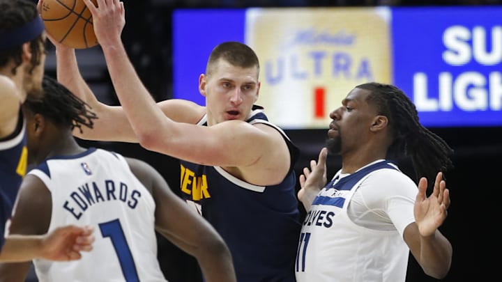Feb 1, 2022; Minneapolis, Minnesota, USA; Denver Nuggets center Nikola Jokic (15) works for position against Minnesota Timberwolves center Naz Reid (11) in the third quarter at Target Center. Mandatory Credit: Bruce Kluckhohn-Imagn Images