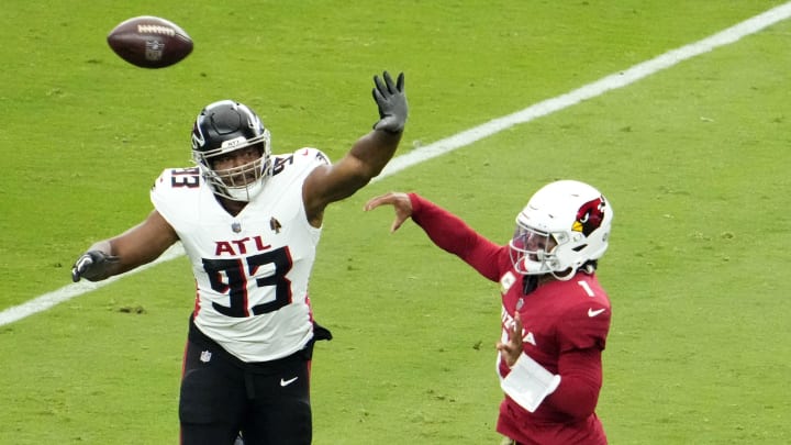Calais Campbell defends a Kyler Murray pass during a 2023 Atlanta Falcons game at State Farm Stadium in Glendale, Arizona.