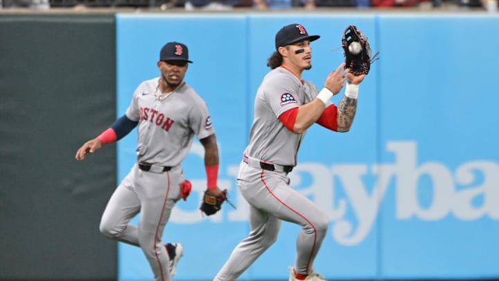 Apr 10, 2026; St. Louis, Missouri, USA;  Boston Red Sox left fielder Jarren Duran (16, right) looks to throw to the infield after catching a St. Louis Cardinals fly ball as teammate Boston Red Sox center fielder Ceddanne Rafaela (3, left) runs behind him at Busch Stadium. Mandatory Credit: Tim Vizer-Imagn Images