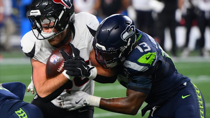 Oct 20, 2025; Seattle, Washington, USA; Seattle Seahawks linebacker Ernest Jones IV (13) tackles Houston Texans tight end Dalton Schultz (86) during the second quarter at Lumen Field. Mandatory Credit: Steven Bisig-Imagn Images