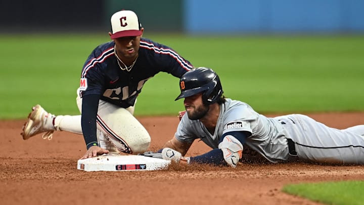 Jul 22, 2024; Cleveland, Ohio, USA; Detroit Tigers third baseman Matt Vierling (8) slides into second with a double as Cleveland Guardians shortstop Brayan Rocchio (4) is late with the tag during the seventh inning at Progressive Field. Mandatory Credit: Ken Blaze-Imagn Images