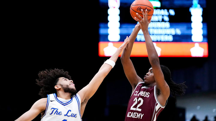 TJ Crumble, left, competes for the Lutheran East varsity boys basketball team during the Division V championship game against Columbus Academy at the University of Dayton Arena in March.