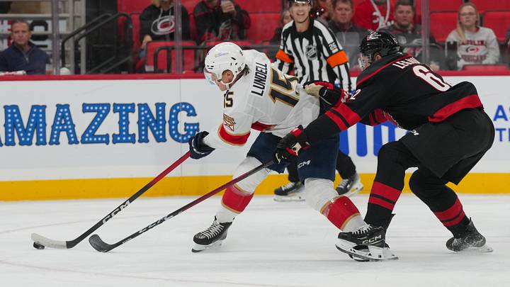 Sep 29, 2026; Raleigh, North Carolina, USA;  Florida Panthers center Anton Lundell (15) carries the puck against Carolina Hurricanes defense Charles Alexis Legault (62) during the second period at Lenovo Center.  Mandatory Credit: James Guillory-Imagn Images