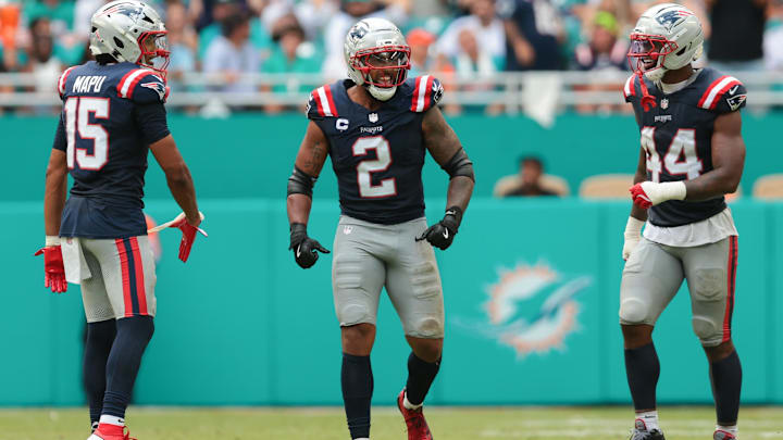 Sep 14, 2025; Miami Gardens, Florida, USA; New England Patriots linebacker Harold Landry III (2) celebrates with linebacker Marte Mapu (15) and linebacker K'Lavon Chaisson (44) after sacking Miami Dolphins quarterback Tua Tagovailoa (not pictured) during the fourth quarter at Hard Rock Stadium. Mandatory Credit: Sam Navarro-Imagn Images