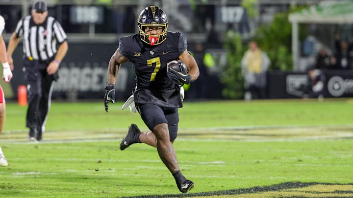 Nov 29, 2024; Orlando, Florida, USA; UCF Knights running back RJ Harvey (7) runs the ball during the second quarter against the Utah Utes at FBC Mortgage Stadium. Mandatory Credit: Mike Watters-Imagn Images