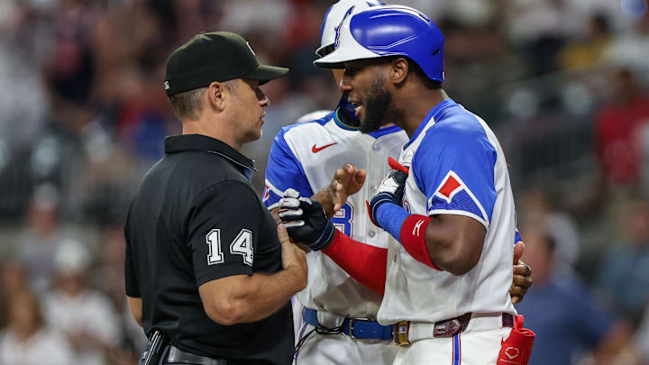 Sep 27, 2025; Cumberland, Georgia, USA; Atlanta Braves outfielder Jurickson Profar (7) speaks to umpire Mark Wegner (14) after a call in the game against the Pittsburgh Pirates during the eighth inning at Truist Park. Sep 27, 2025; Cumberland, Georgia, USA; Atlanta Braves outfielder Jurickson Profar (7) speaks to umpire Mark Wegner (14) after a call in the game against the Pittsburgh Pirates during the eighth inning at Truist Park.
