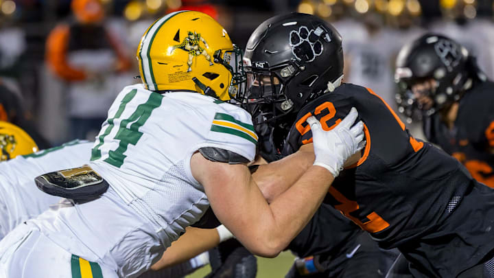 Brighton's Jaden Rogers (right) and Howell's Bobby Kanka battle in the trenches during a rivalry football game Friday, Oct. 13, 2023.
