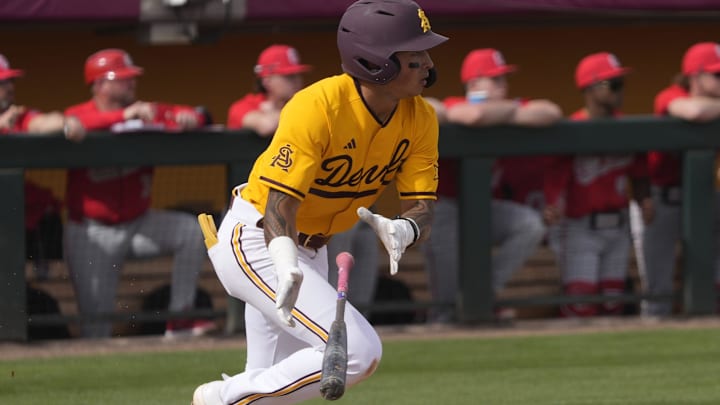 Arizona State's Nu'u Contrades drops his bat after an RBI single against Ohio State at Phoenix Municipal Stadium on Sunday, Feb. 16, 2025.