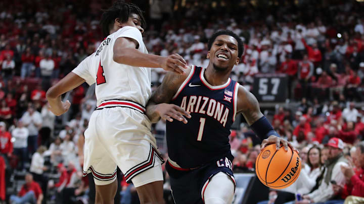 Arizona Wildcats guard Caleb Love (1) reacts after being blocked by Texas Tech Red Raiders guard Christian Anderson (4) in the first half at United Supermarkets Arena. Arizona Wildcats guard Caleb Love (1) reacts after being blocked by Texas Tech Red Raiders guard Christian Anderson (4) in the first half at United Supermarkets Arena.