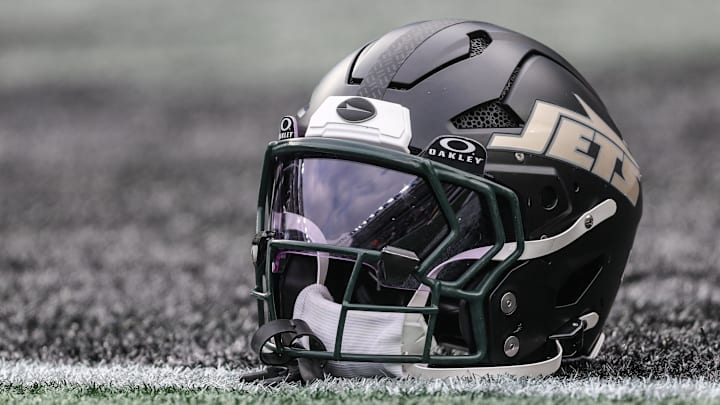 Dec 7, 2025; East Rutherford, New Jersey, USA; A general view of a Gotham City football rivalries helmet resting on the field before the game against the Miami Dolphins at MetLife Stadium. Mandatory Credit: Vincent Carchietta-Imagn Images Dec 7, 2025; East Rutherford, New Jersey, USA; A general view of a Gotham City football rivalries helmet resting on the field before the game against the Miami Dolphins at MetLife Stadium. Mandatory Credit: Vincent Carchietta-Imagn Images