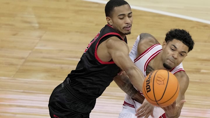 Ball State guard Juwan Maxey (3, left) and Wisconsin guard Nick Boyd (2) vie for a rebound during the first half of their game Tuesday, November 11, 2025 at the Kohl Center in Madison, Wisconsin.