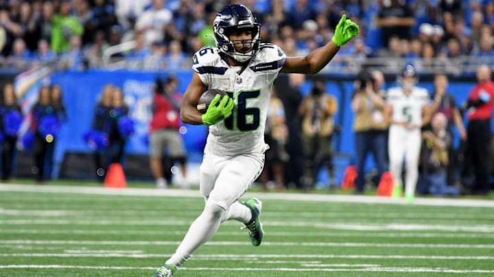 Sep 30, 2024; Detroit, Michigan, USA; Seattle Seahawks wide receiver Tyler Lockett (16) runs the ball against the Detroit Lions in the third quarter at Ford Field. Mandatory Credit: Eamon Horwedel-Imagn Images
