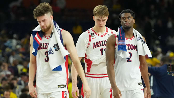 Apr 4, 2026; Indianapolis, IN, USA;  Arizona Wildcats guard Dwayne Aristode (2), Arizona Wildcats guard Anthony Dell'orso (3) and Arizona Wildcats guard Jackson Cook (11) react after losing to the Michigan Wolverines during a semifinal of the Final Four of the men's 2026 NCAA Tournament at Lucas Oil Stadium. Mandatory Credit: Robert Deutsch-Imagn Images