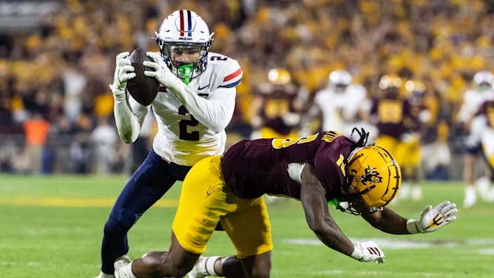 Nov 28, 2025; Tempe, Arizona, USA; Arizona Wildcats defensive back Treydan Stukes (2) intercepts the ball against Arizona State Sun Devils wide receiver Jaren Hamilton (16) in the second half during the 99th Territorial Cup at Mountain America Stadium. Mandatory Credit: Mark J. Rebilas-Imagn Images