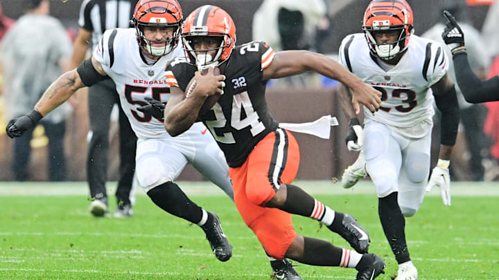 Sep 10, 2023; Cleveland, Ohio, USA; Cleveland Browns running back Nick Chubb (24) runs with the ball as Cincinnati Bengals linebacker Logan Wilson (55) and safety Dax Hill (23) defend during the first half at Cleveland Browns Stadium. Mandatory Credit: Ken Blaze-Imagn Images