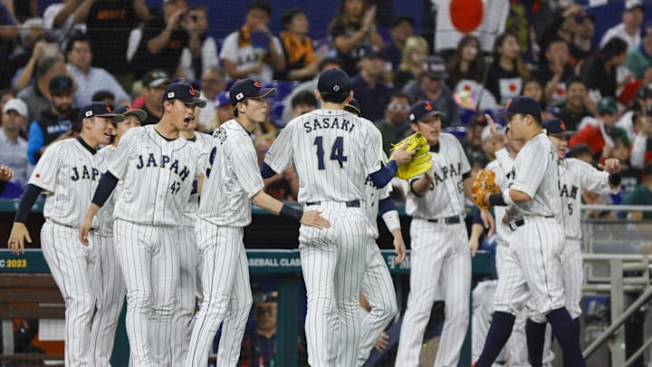 Mar 20, 2023; Miami, Florida, USA; Japan starting pitcher Roki Sasaki (14) celebrates with teammates after the first inning against Mexico at LoanDepot Park. Mar 20, 2023; Miami, Florida, USA; Japan starting pitcher Roki Sasaki (14) celebrates with teammates after the first inning against Mexico at LoanDepot Park.