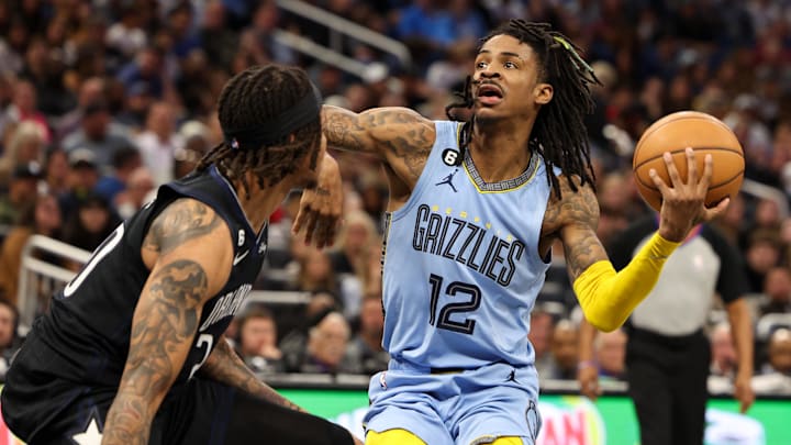 Memphis Grizzlies guard Ja Morant (12) looks to shoot past Orlando Magic guard Markelle Fultz (20) in the fourth quarter at Amway Center. Mandatory Credit: Nathan Ray Seebeck-Imagn Images